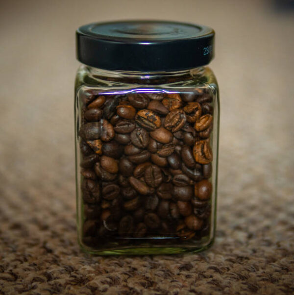 Fresh roast beans of coffee in a jar on a nice texture background