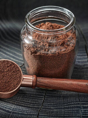 Coffee ground in glass jar and spoon with wooden handle