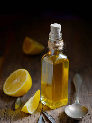 Liver detox with olive oil and lemon fruits on the wooden table